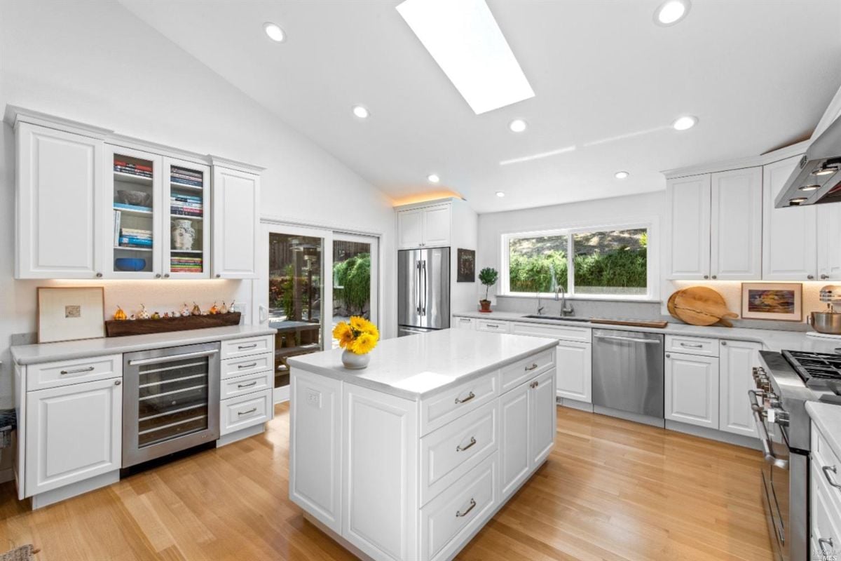 Kitchen with wood flooring, skylights and custom lighting.