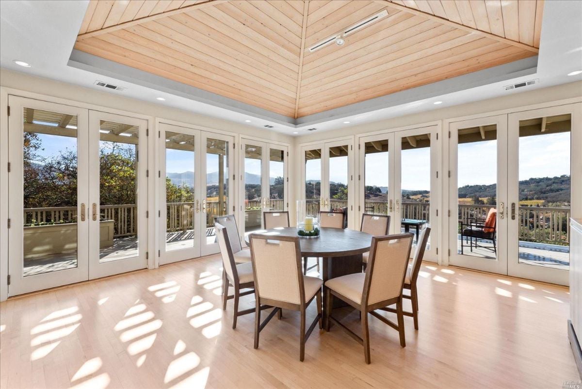 Dining room with a Cathedral ceiling wood flooring.