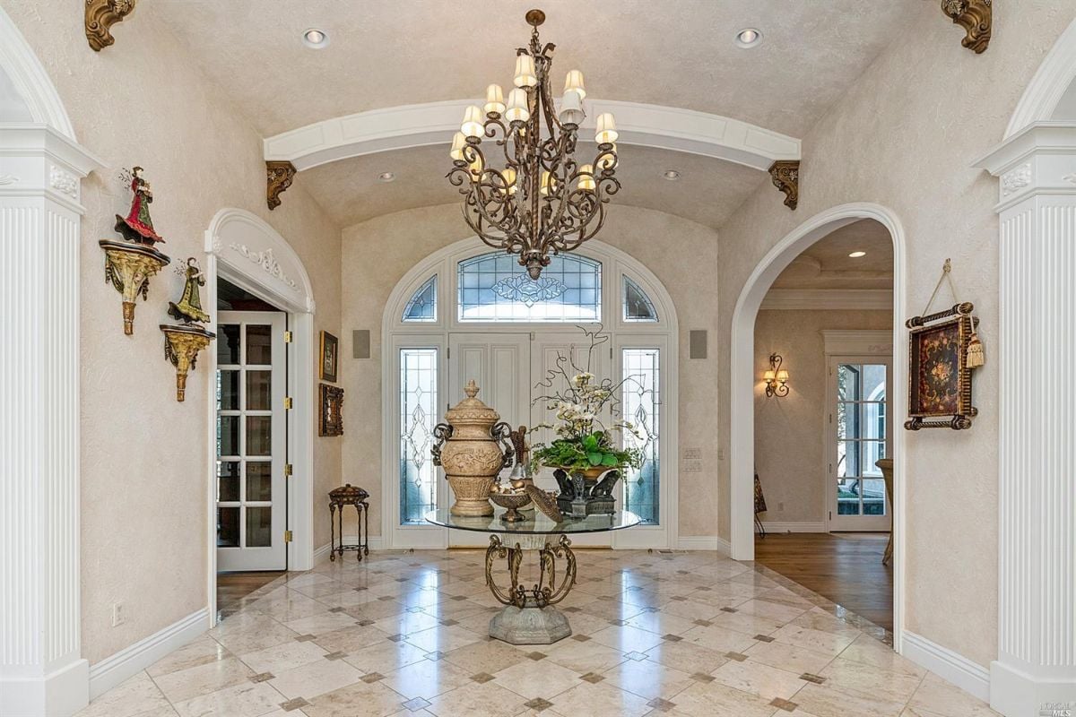 Formal entry with a huge door and chandelier.
