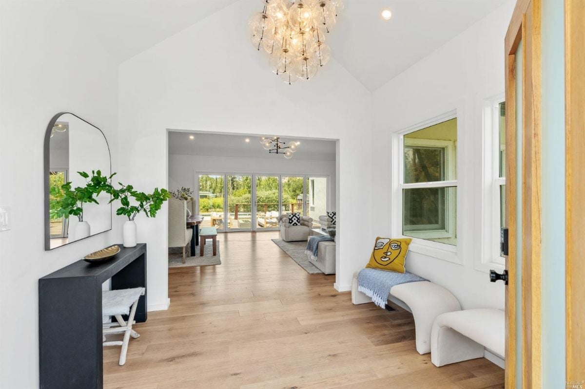 Foyer with wood floorings and chandelier.