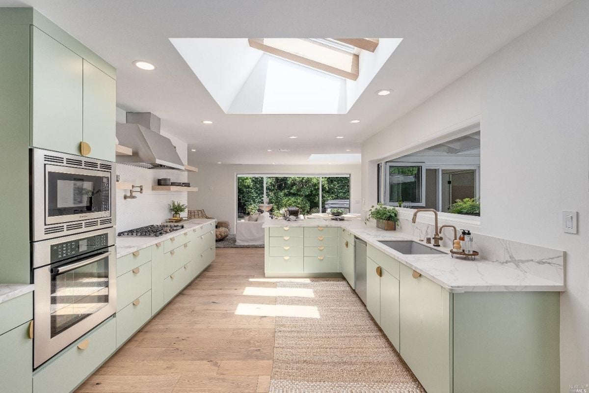Kitchen with skylights, high-end appliances and custom cabinetry.