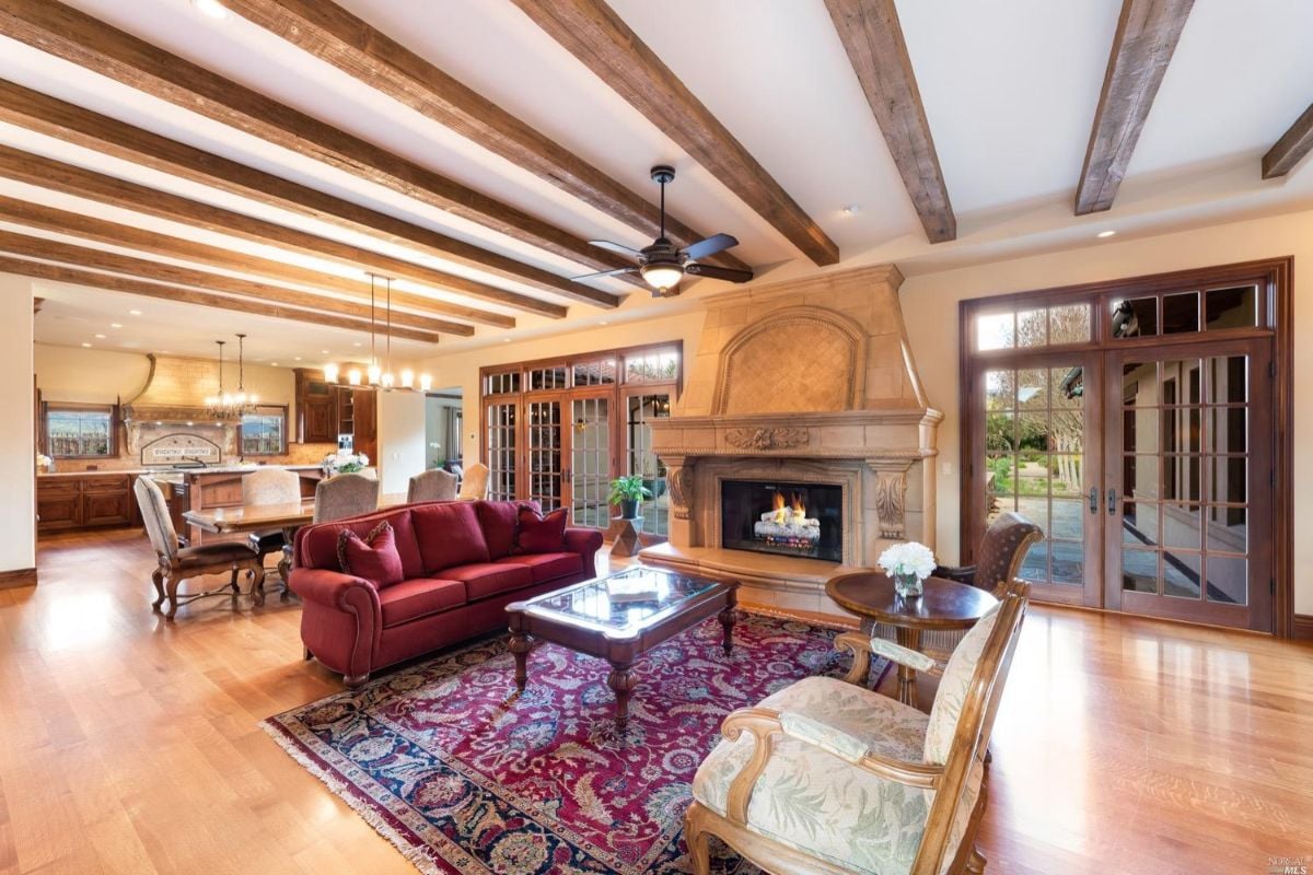 Living room with an open beam ceiling.