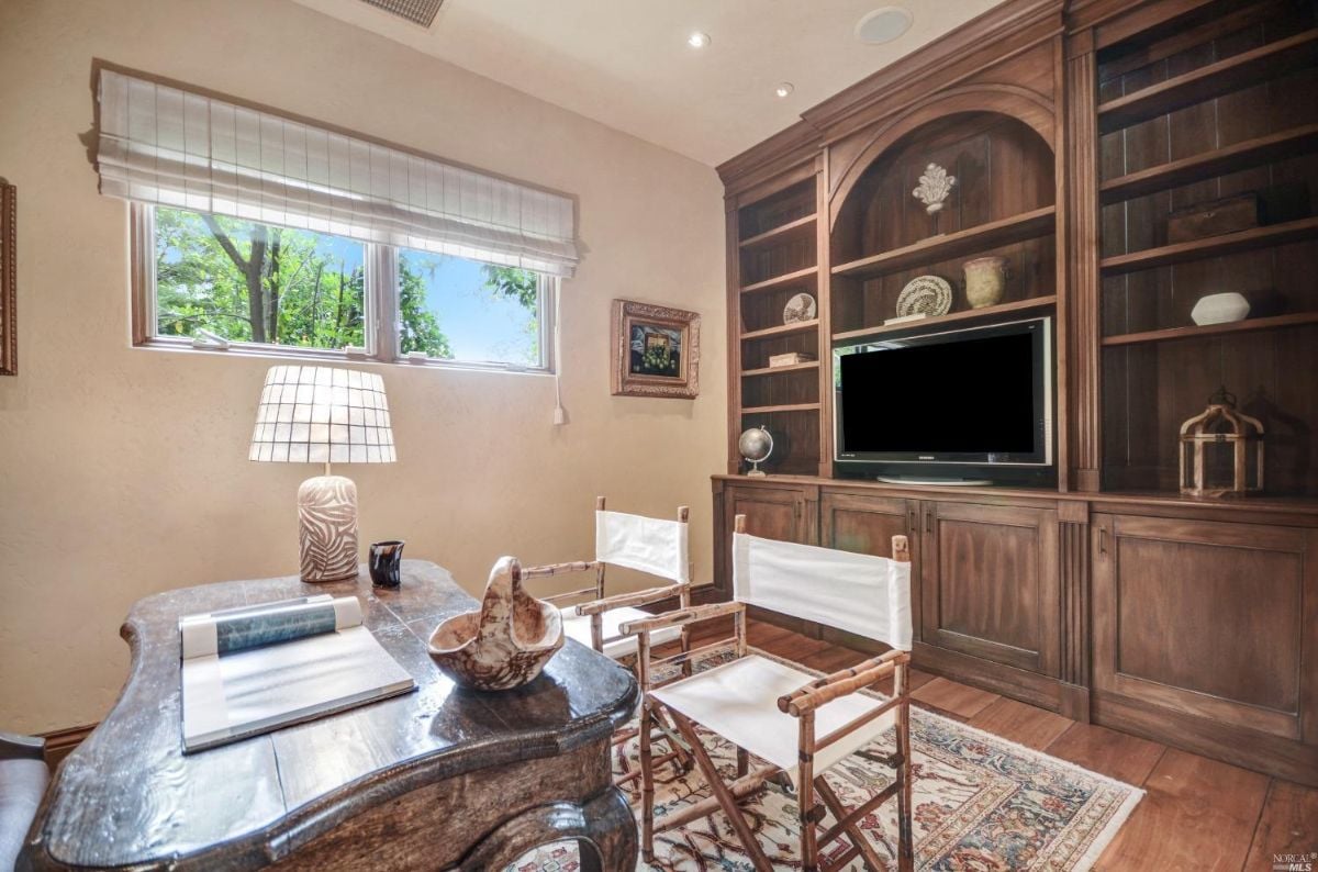 Home office with food flooring and and wooden furniture.
