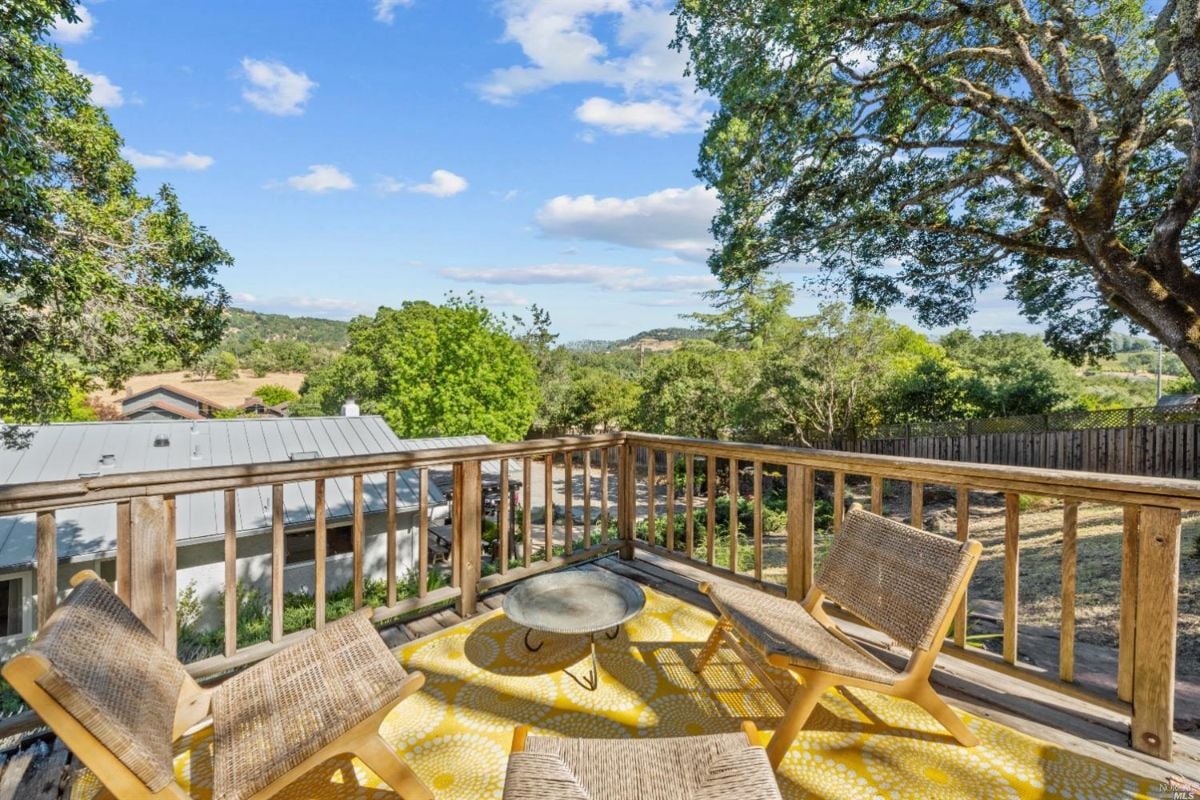 Patio with chairs and a view of the mountains.