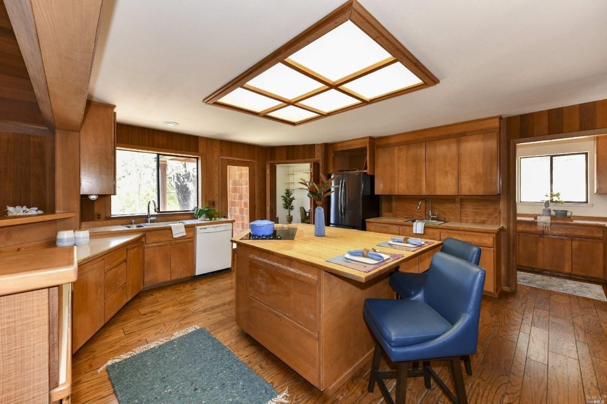 Kitchen with a wooden counter top and skylight.