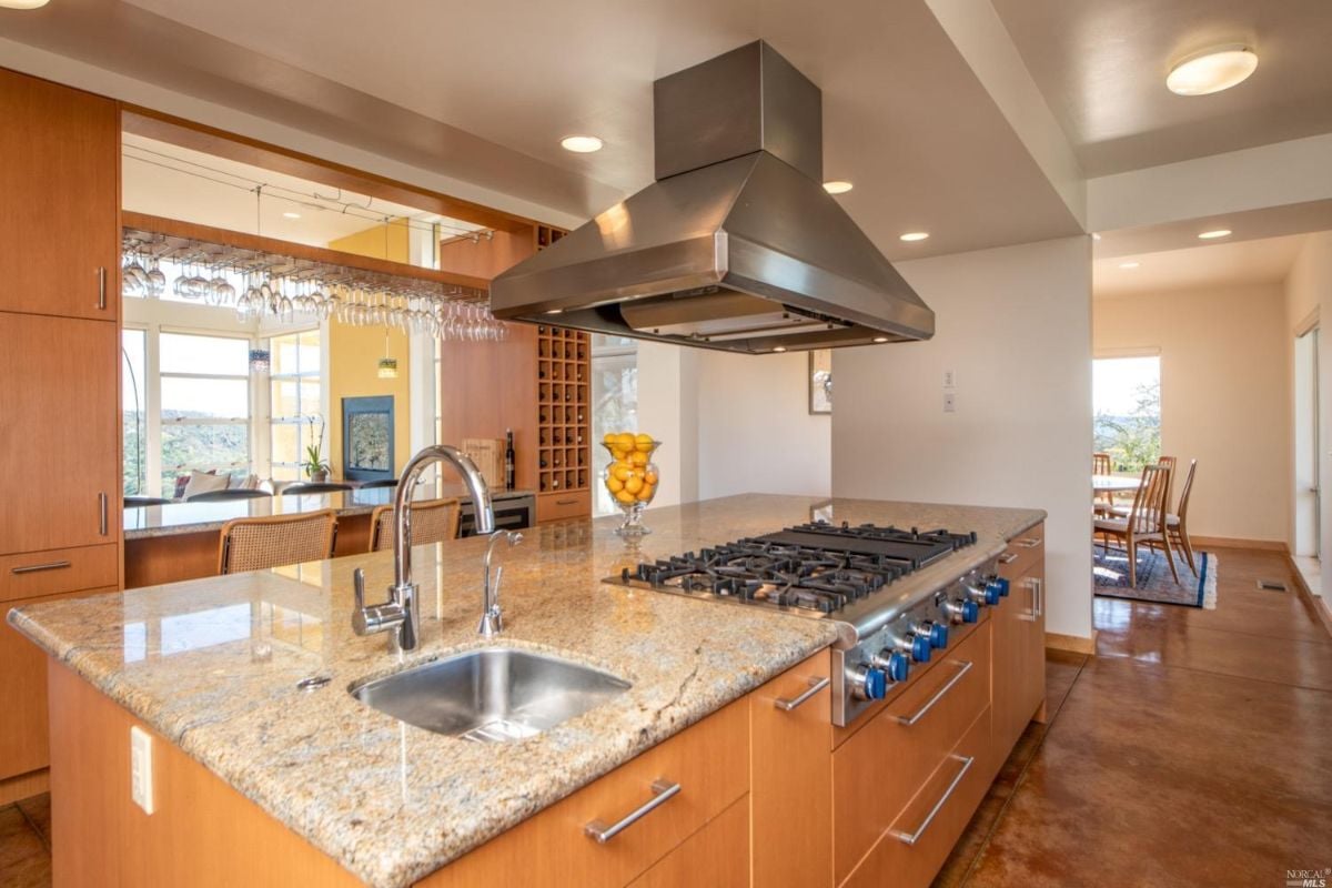 Kitchen with granite counters, huge chef's island and prep sink.