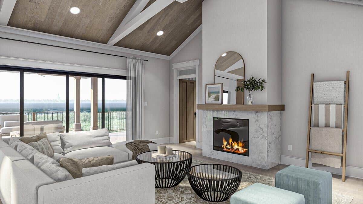 The great room includes a marble fireplace and sliding glass doors that open onto the rear deck.