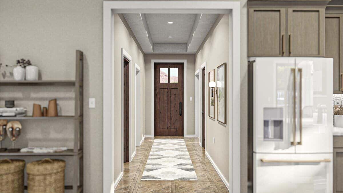 The foyer has a glazed front door, a tray ceiling, and a patterned runner.