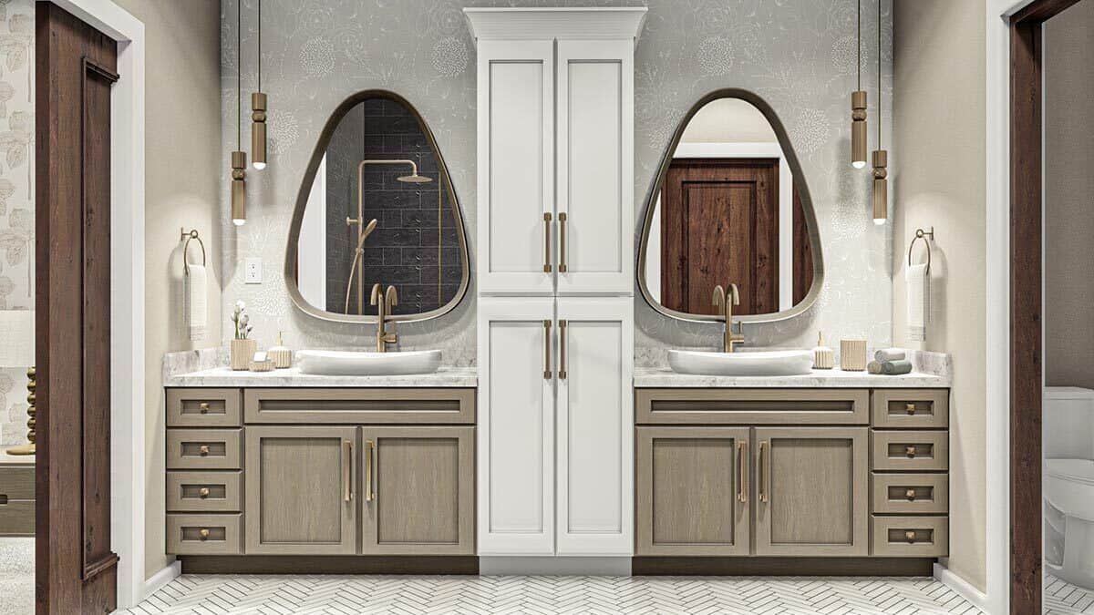 Primary bathroom with his and her vanities separated by a linen closet.