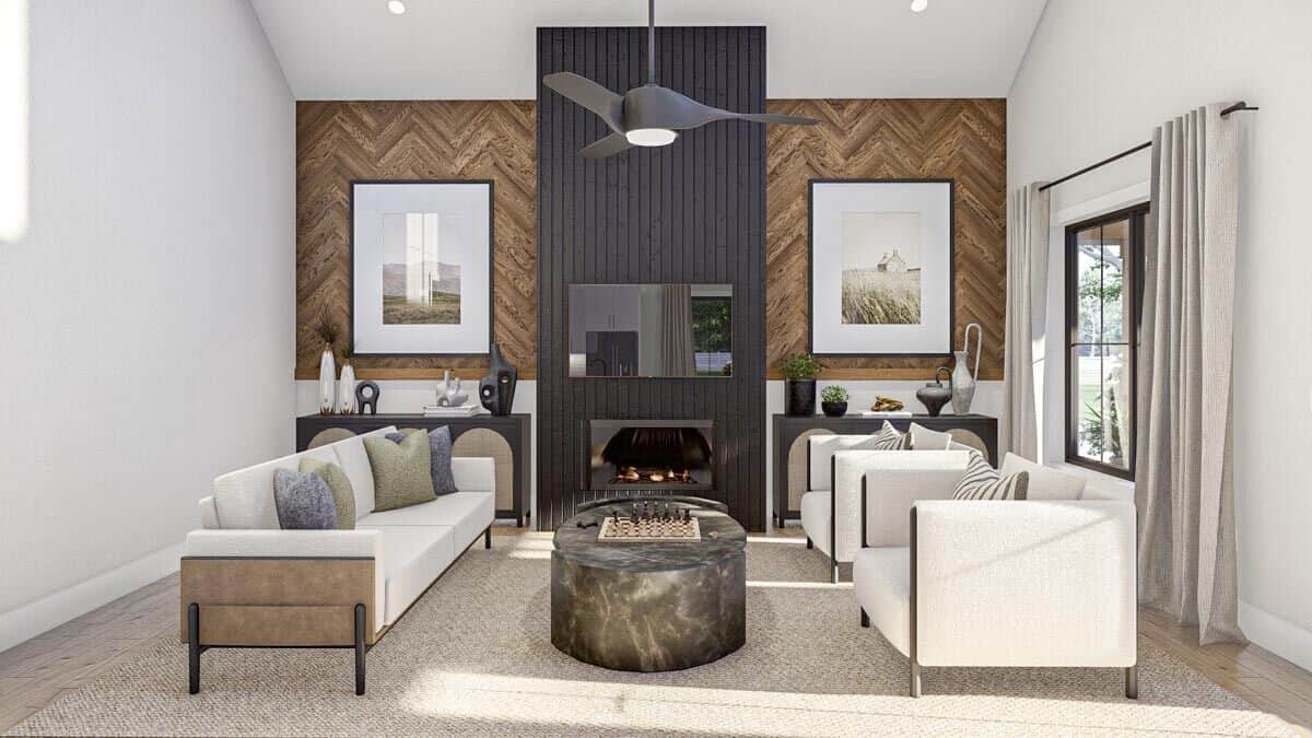 Great room with beige seats, a marble coffee table, and a fireplace flanked by dark wood cabinets.