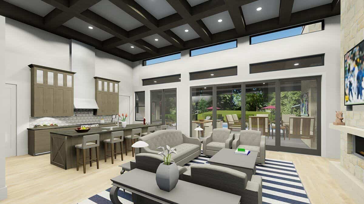 Combined living room and kitchen with a beamed ceiling and sliding glass doors that open to the back porch.