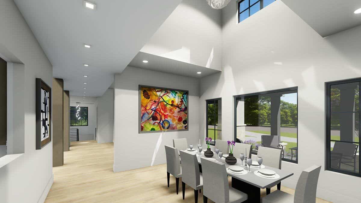 Dining room with a modern dining set, a large painting, and huge windows that look out the front yard,