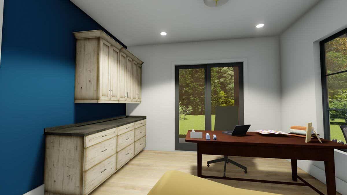 Home office with built-in cabinets, a dark wood desk, and outdoor access via glass sliders.