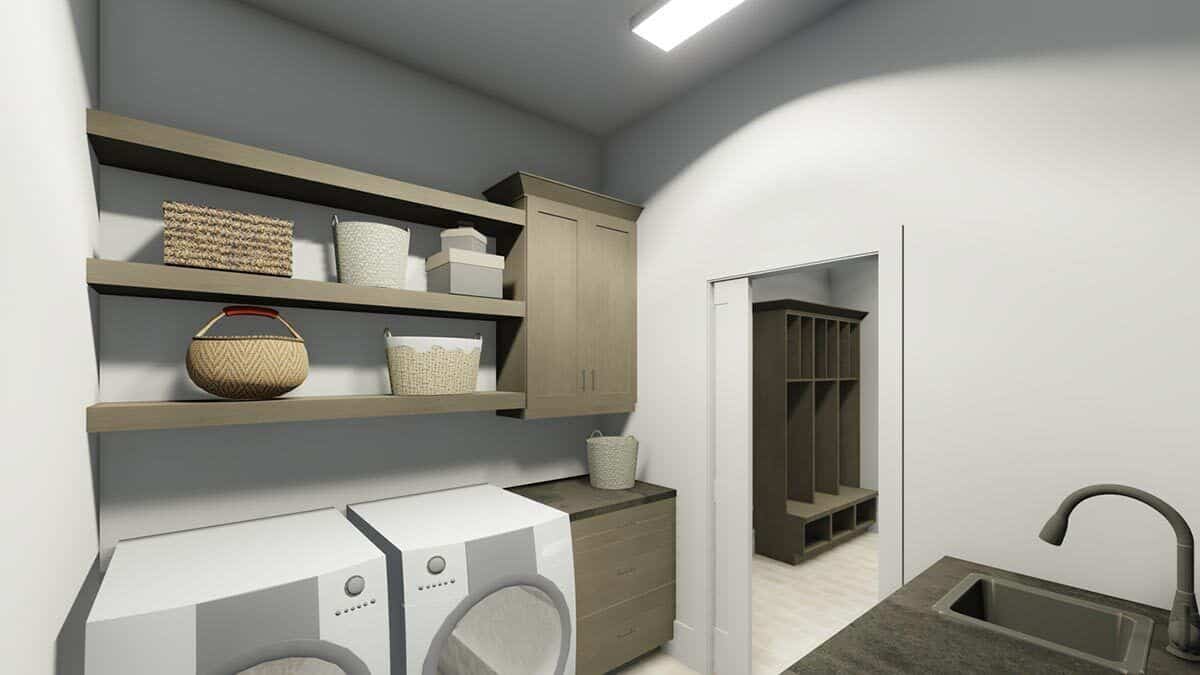 Laundry room with floating shelves, matching cabinets, front-load appliances, a sink, and a pocket door that opens to the mudroom.