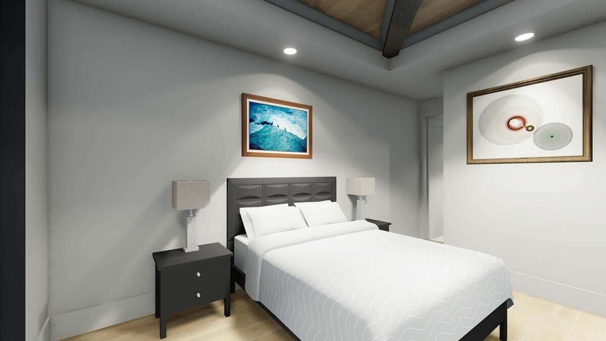 Secondary bedroom with a tray ceiling and a black bed flanked by matching nightstands.