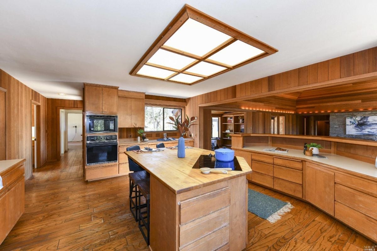 Kitchen with wooden cabinets, skylights and a large island.
