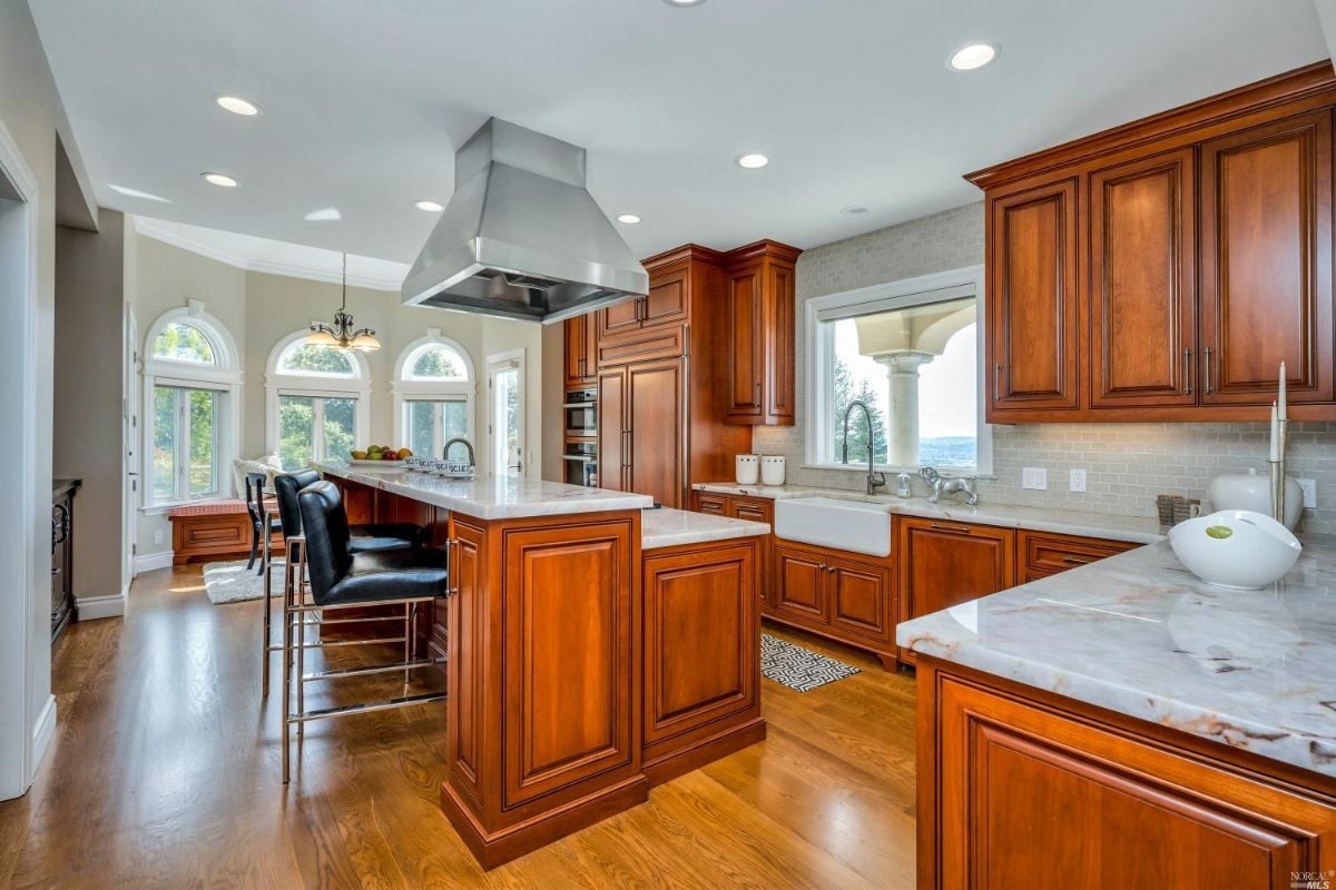 Kitchen with a large island and wooden cabinets.