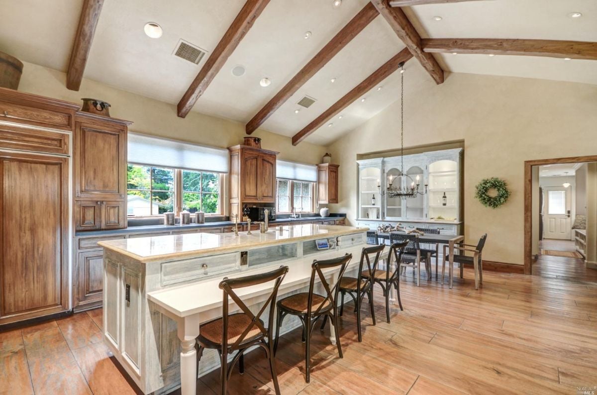 Kitchen with Cathedral ceiling, wooden cabinets and wood flooring.