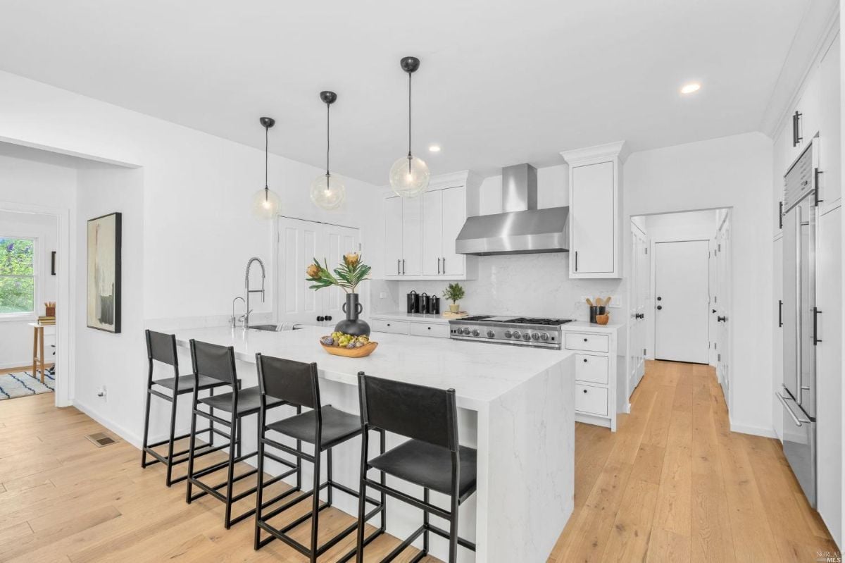 Kitchen with white cabinets and a large island.