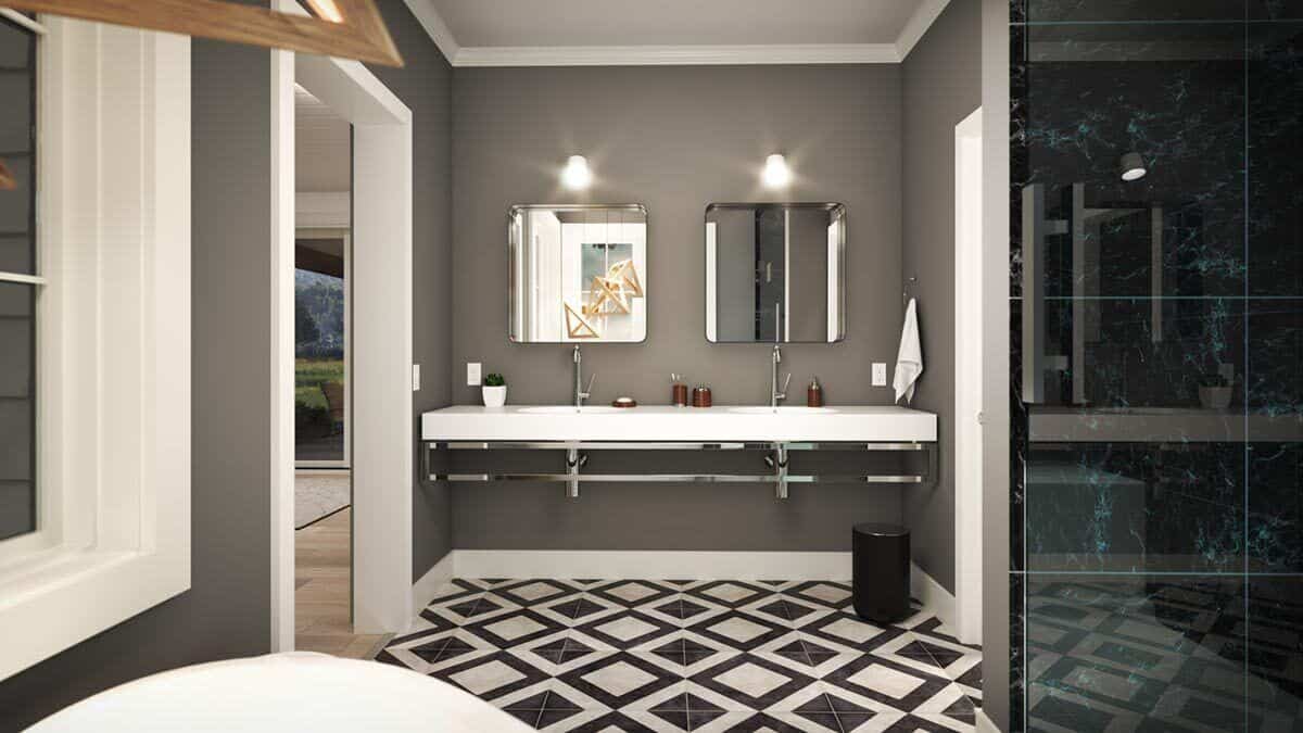 Primary bathroom with double sinks, a walk-in shower, and a pattern tiled flooring.
