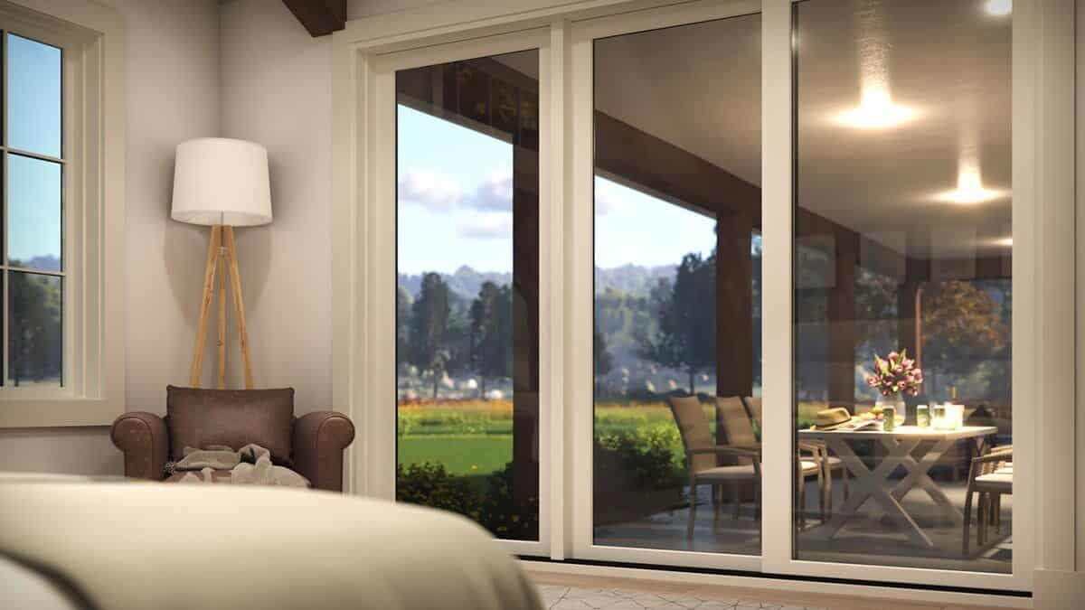 Sliding glass doors extend the primary bedroom onto the covered patio.