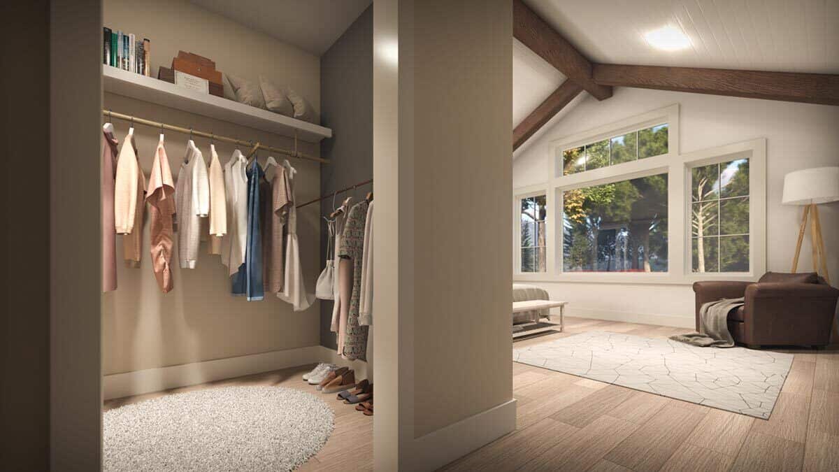 Primary walk-in closet with multicolored walls and a hardwood floor topped with an oval rug.