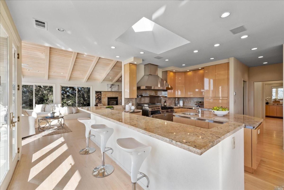 Kitchen with large island and wood flooring.
