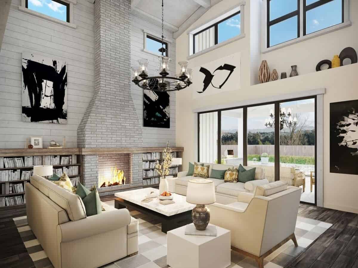 Great room with a two-story ceiling, a brick fireplace, leather seats, and sliding glass doors that open onto a covered porch.