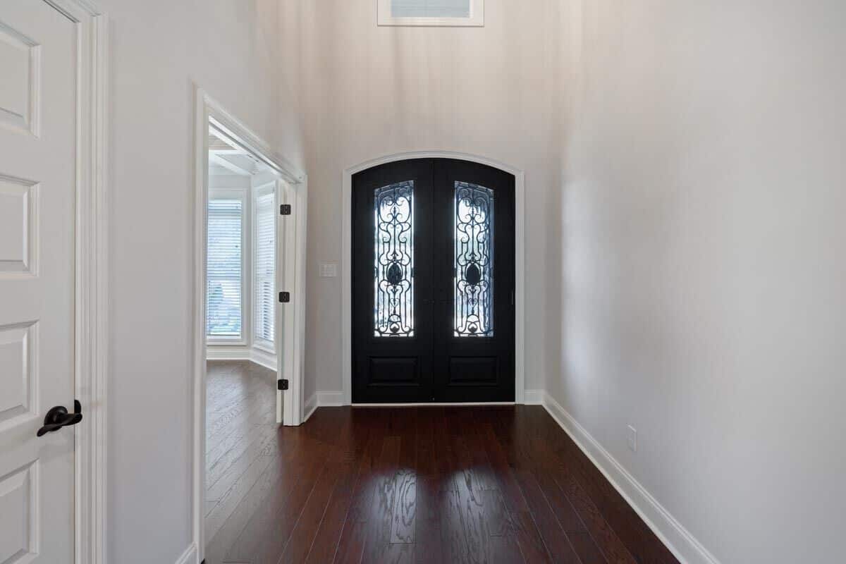 Foyer with a French entry door adorned with intricate detailing.