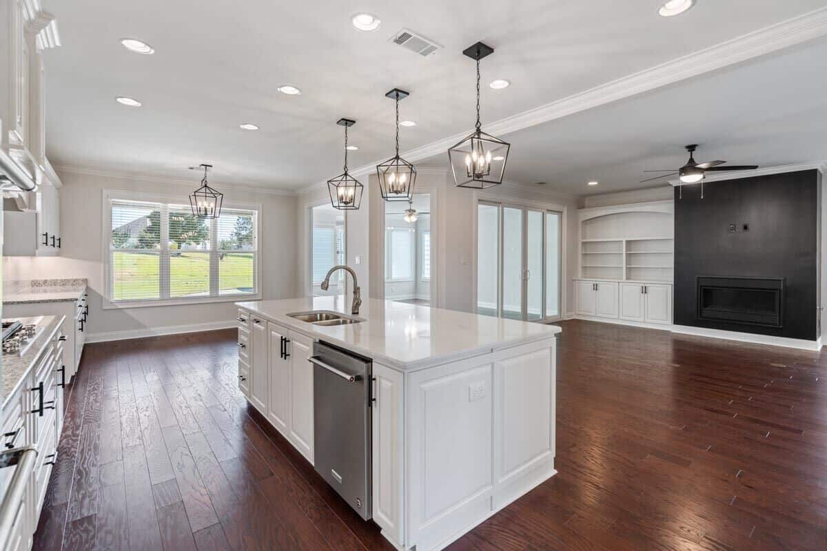 Kitchen island with double sinks and dishwasher overlooking the family room.