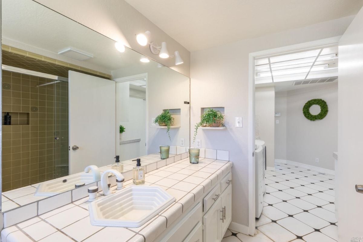 Bathroom with sink and a huge mirror.