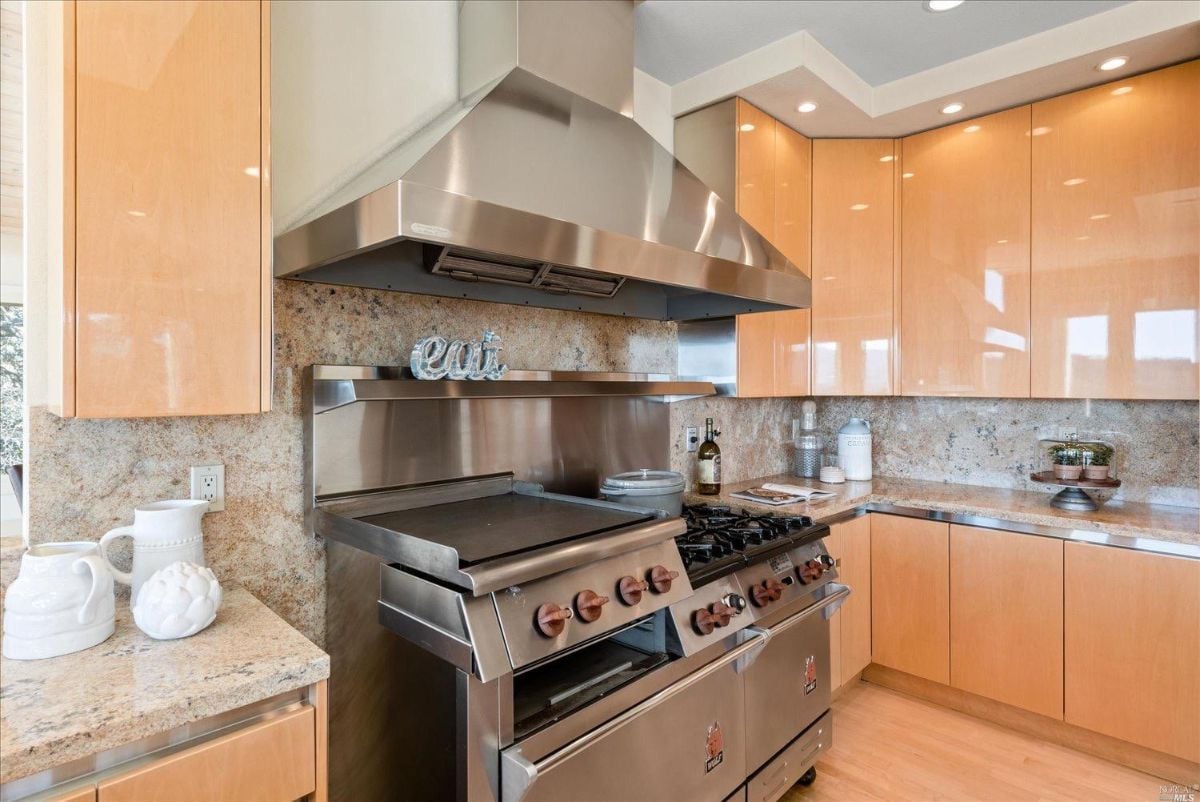 Kitchen with a stove, oven, and wooden cabinets.