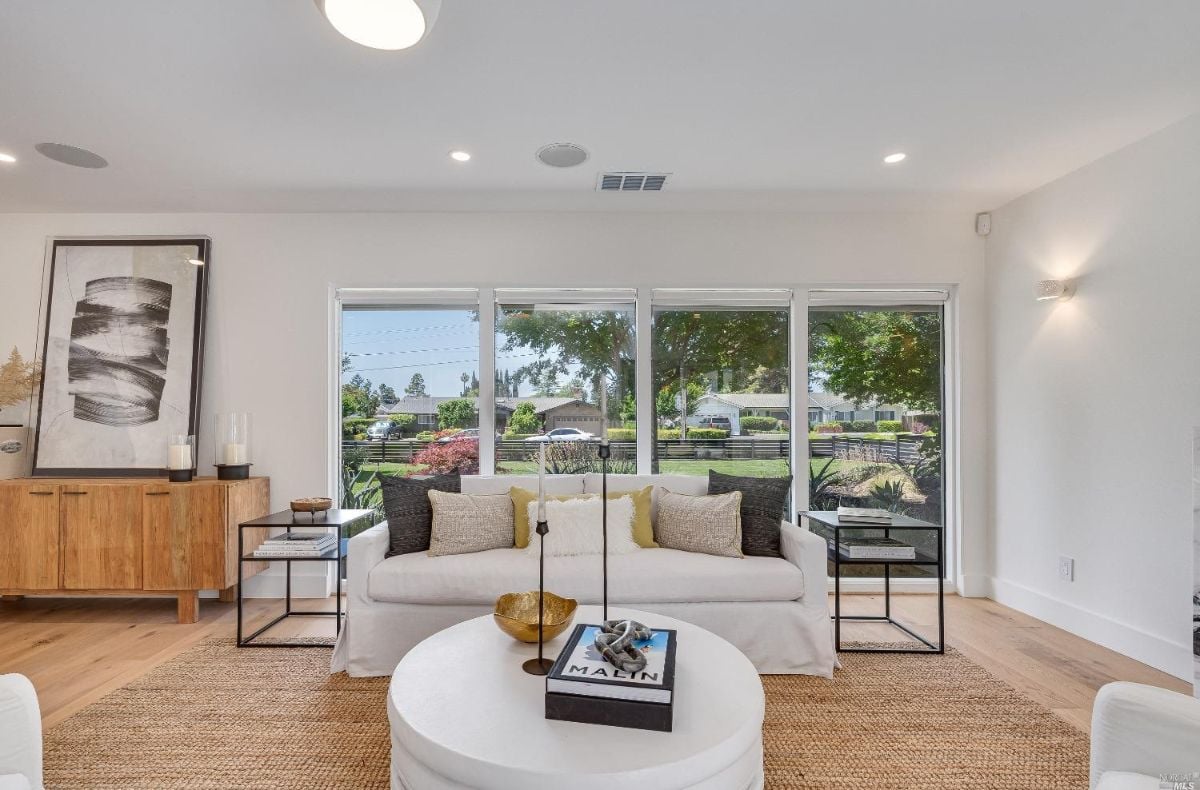Living room with couches and a large window.
