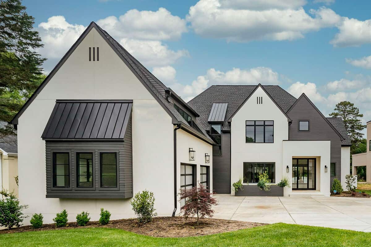 Front view of the house with steep gables, metal roof accents, and a sleek entry.