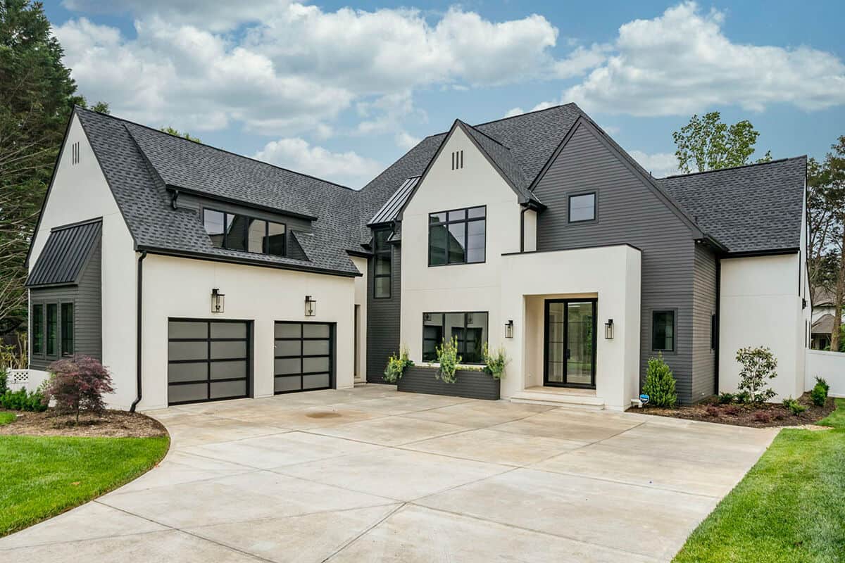 An angled view showcases the 2-car side-entry garage topped with shed dormers.