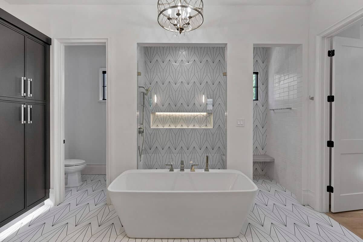 Primary bathroom with a soaking tub, a water closet, and a tiled shower.
