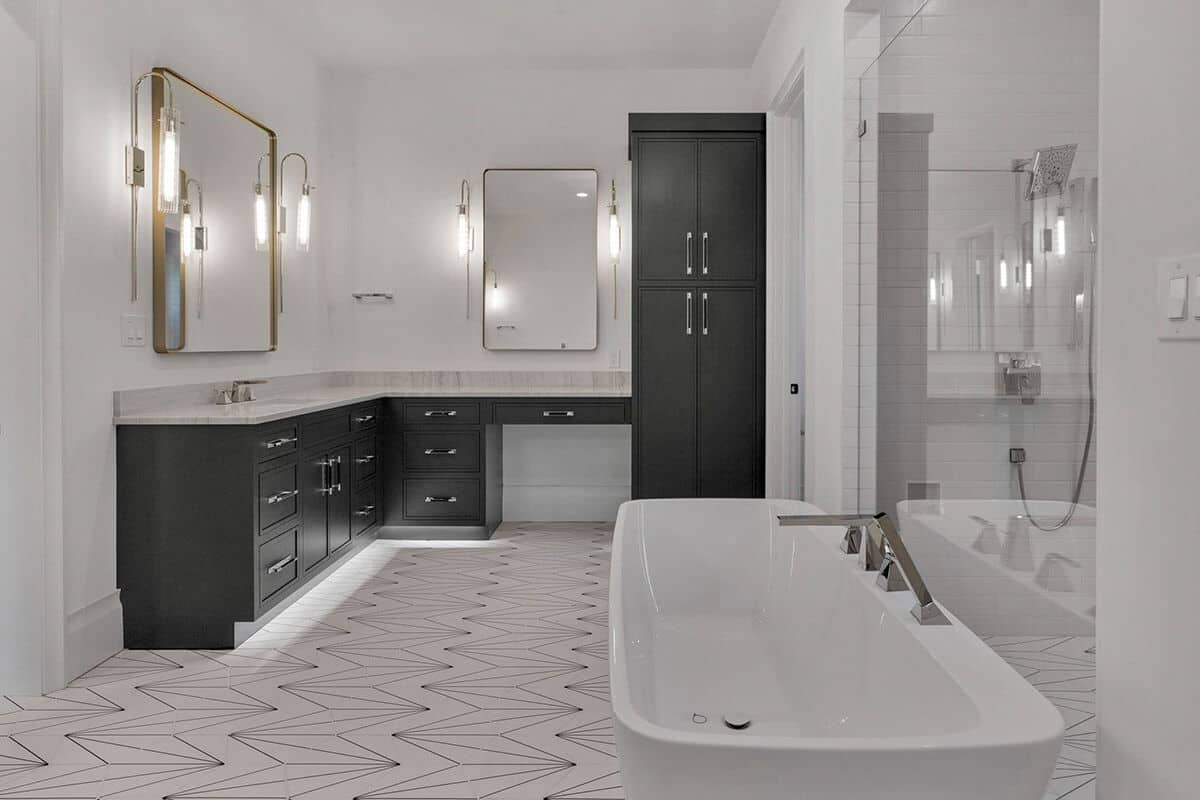 A large vanity integrated with a makeup counter and linen closet complete the primary bathroom.