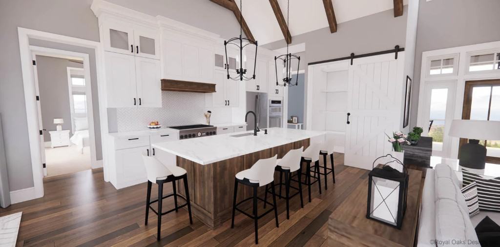 Kitchen with white cabinetry, a breakfast island, and a sliding barn door that unveils the pantry.