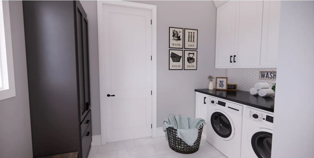 Laundry room with a storage closet, overhead cabinets, and front-load washer and dryer.