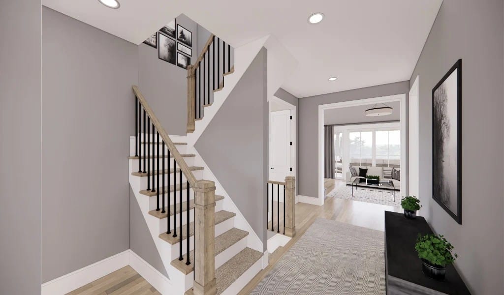 Foyer with a dark wood console table and a staircase leading to the secondary bedrooms.