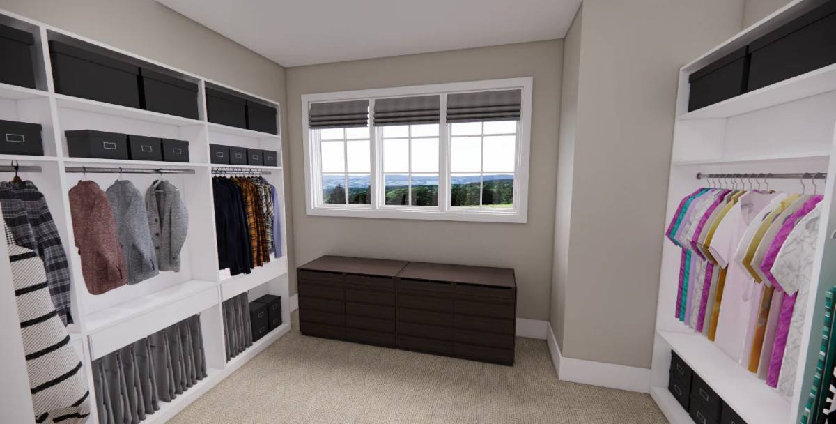 Primary walk-in closet with carpeted floor, plenty of storage, and a bench under the windows.