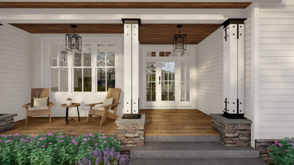A closer look at the covered front porch with wooden lounge chairs and a glazed entry door.
