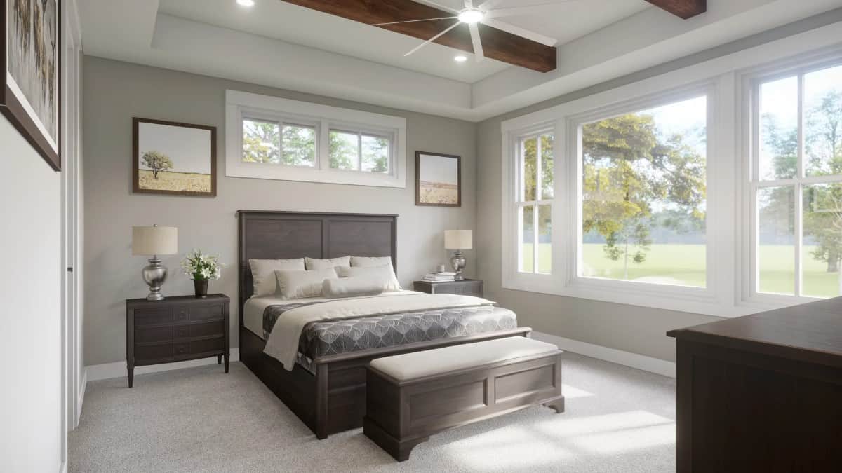 Primary bedroom with spectacular rearward views and a tray ceiling accentuated with exposed wood beams.