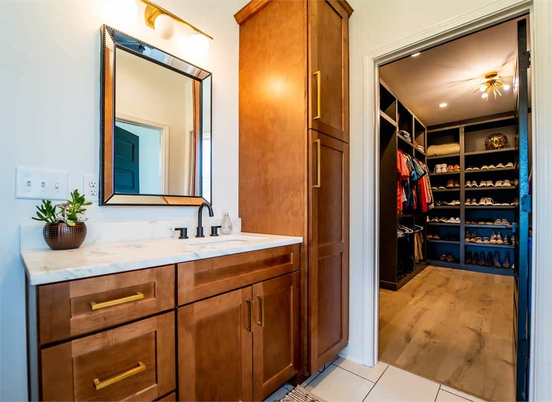 The primary bathroom includes a marble-top vanity and a walk-in closet.