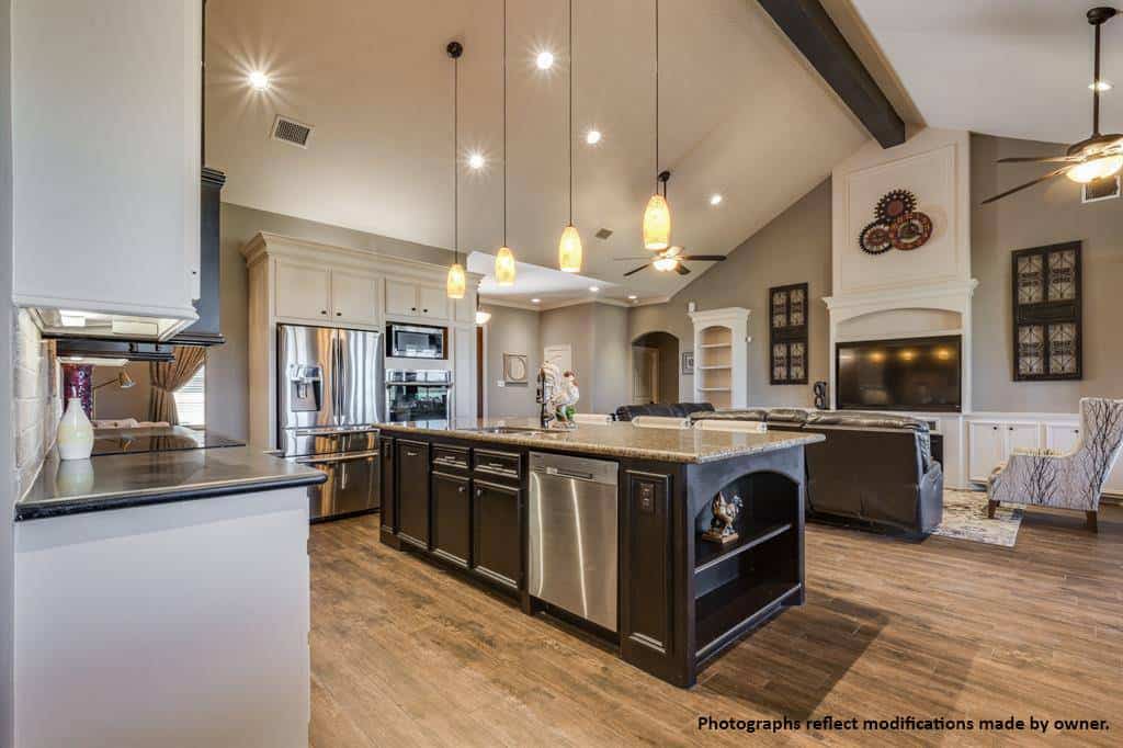 Kitchen island with built-in shelves and cabinets overlooking the living room.