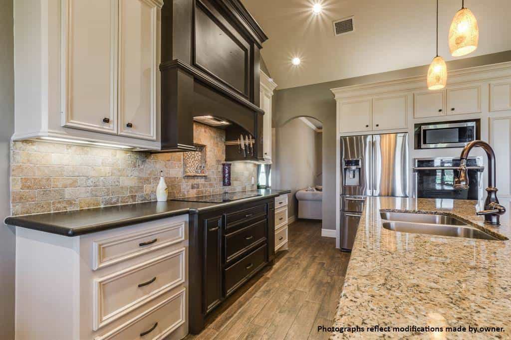 The kitchen includes high-end appliances and an archway that leads to the formal dining room.