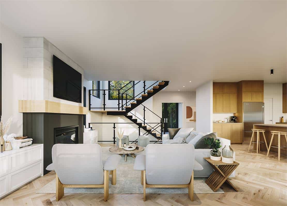 Living room with a view of the kitchen and staircase in the foyer.