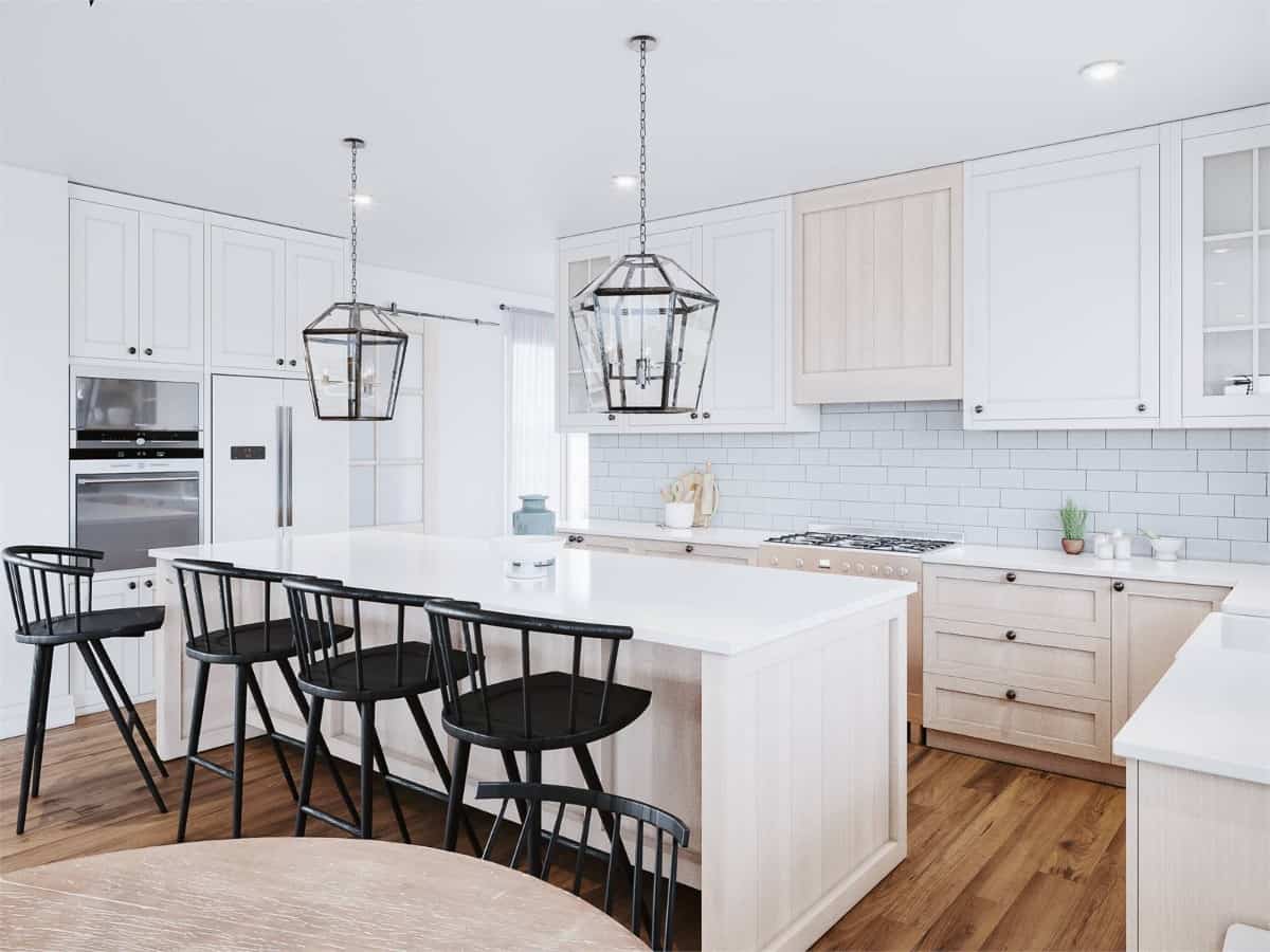 The kitchen offers lots of storage, modern appliances, and a center island lined with four bar stools.