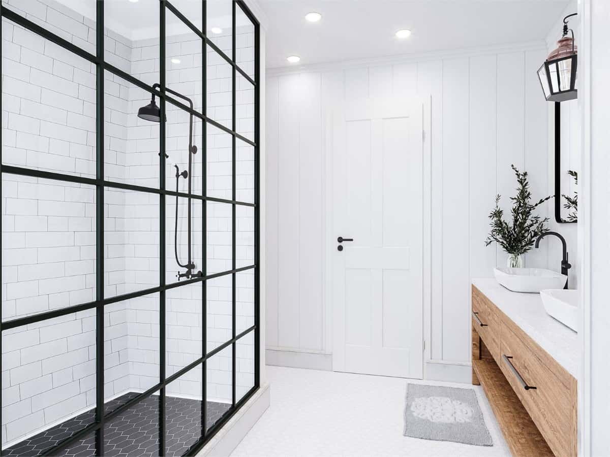 The primary bathroom offers a dual sink vanity and a wet room with a wrought iron shower.