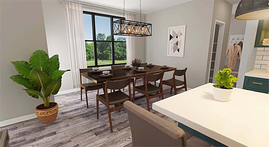 Dining area with a dark wood dining set well-lit by a large window and a linear chandelier.